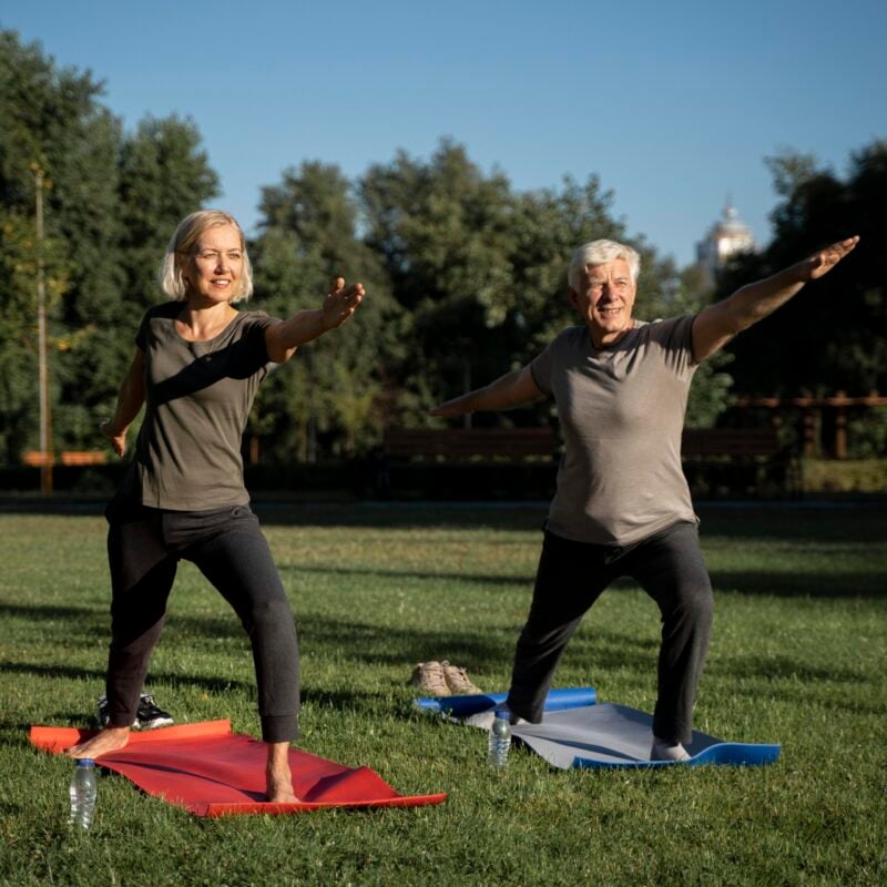 mature-couple-doing-yoga-outside